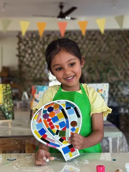 This little girl is so happy with her hot air balloon mosaic. The bright colors and fun shape make it a perfect decoration for her room.