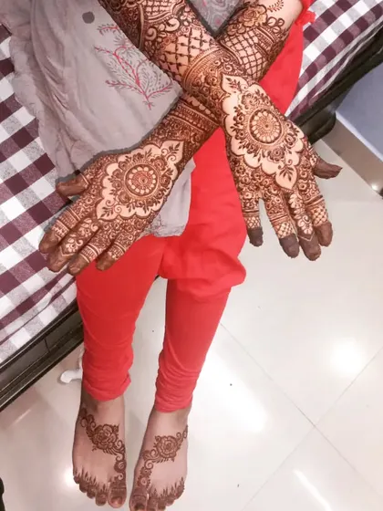 A beautiful design for Misba, with intricate henna on her hands and simpler, elegant patterns on her feet for her son's first birthday party.