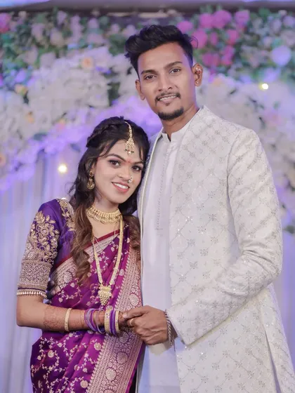 A classic portrait of the couple smiling for the camera. This shot is perfect for capturing their happiness and beautiful traditional outfits on their engagement day.