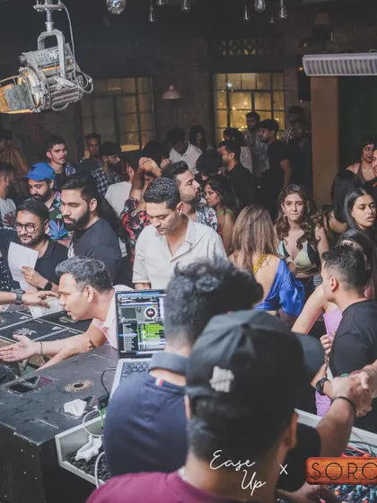 A view from behind the decks, showing a packed and lively dance floor at SORO.
