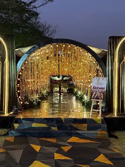 First impressions matter. We design and construct breathtaking entrances like this one for a sangeet night, featuring custom arches, elegant chandeliers, and intricate light decorations to create an unforgettable welcome.