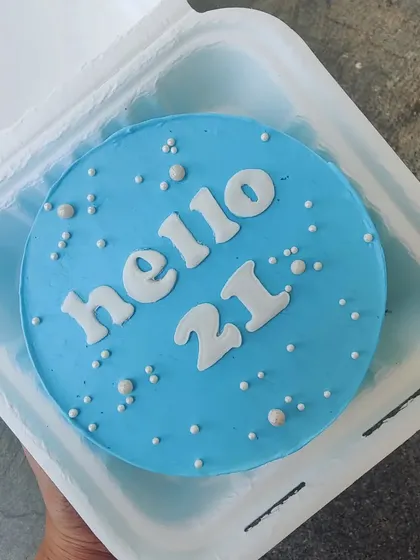 A simple and bold "Hello 21" bento cake in a striking blue color.