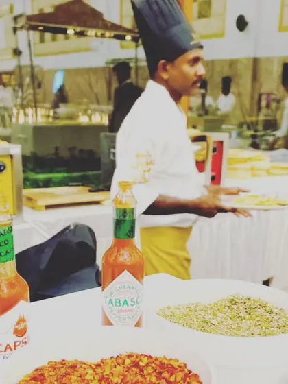 A glimpse of our live pizza station, complete with a variety of fresh toppings and seasonings. We use professional ovens to serve perfectly cooked vegetarian pizzas.