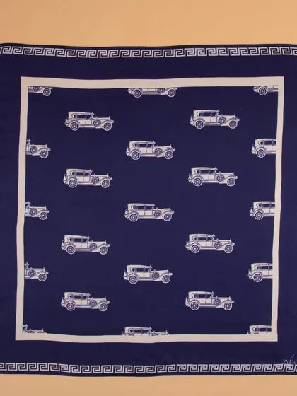 A navy blue pocket square with a vintage car print, shot flat to display the entire design.