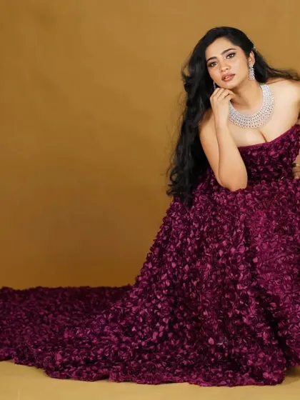 A seated portrait that lets the voluminous tail of the wine floral gown spread out beautifully.