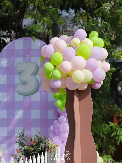 We created whimsical trees made entirely of pastel balloons. This unique decor element added height, color, and a sense of playful fantasy to the outdoor garden party setting.