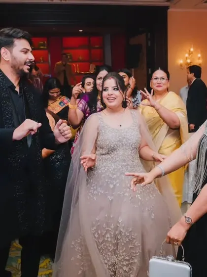 The couple dancing with their guests, fully immersed in the celebration and joy of their reception party.