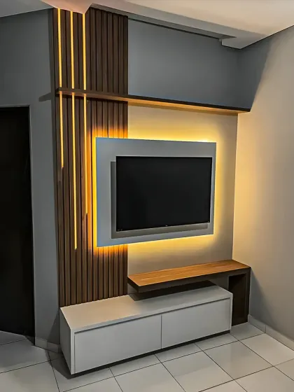 We created a bold, modern look with this TV unit, using dramatic vertical LED strips alongside wood-finish panels. The floating white console keeps the design feeling light and uncluttered.