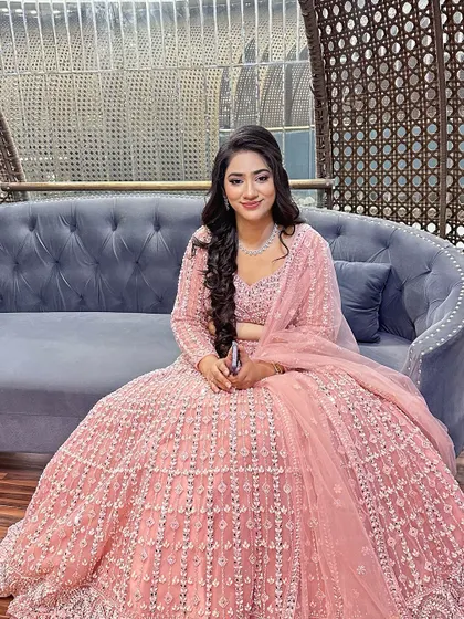 A full shot showing the beautiful details of the lehenga and the complementary soft glam makeup.