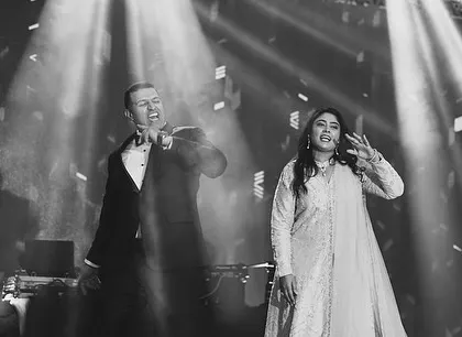 This picture speaks a thousand emotions. A candid black and white shot capturing a powerful moment between two performers on stage.