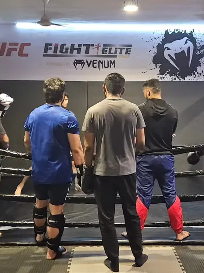 Focus is key during sparring. Here, I am observing our fighters in the ring, providing instruction and ensuring they are applying their techniques correctly and safely.