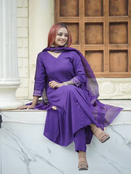 A stylish and relaxed pose on the marble ledge, perfect for a fashion or lifestyle shoot.