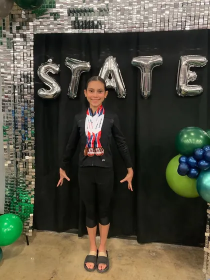 Look at all those medals! This Xcel athlete is loaded with hardware after an amazing performance at the State meet.