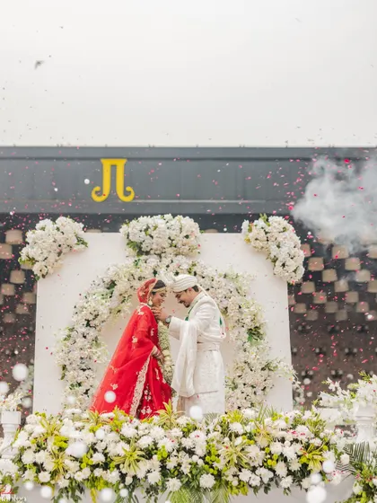 A tender moment during the Varmala ceremony. I captured Rahul gently touching Riya's chin, a small, intimate gesture amidst the grand celebration that speaks volumes about their love.