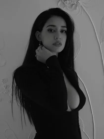 A direct and powerful gaze from Disha Patani. The clean hair and makeup ensure that nothing distracts from her expression in this striking black and white photo.