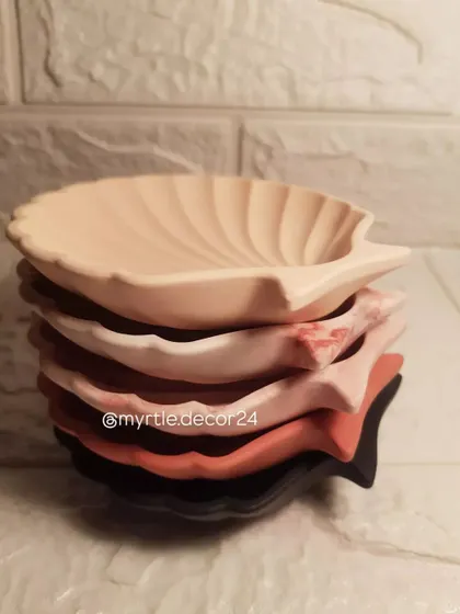 A stack of our mini shell dishes in various colors and finishes. Each one is handmade and unique, ready to find a home.