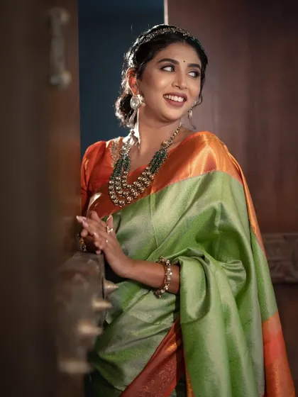 A joyful, smiling portrait, her happiness and the beautiful colours of her outfit creating a wholesome and beautiful image.