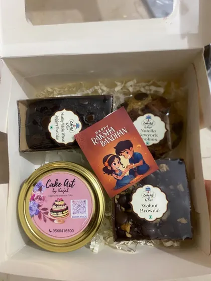 Here is another variation of a Rakhi hamper, combining different treats. This one contains a whole wheat jaggery mini loaf, a walnut brownie, a chocolate truffle cake jar, and a Nutella New York cookie.