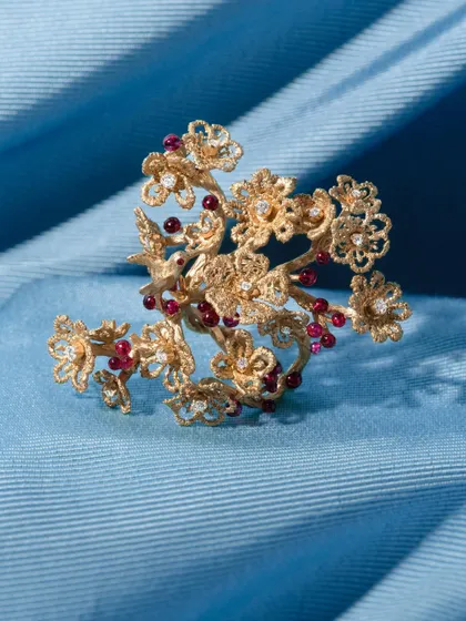 The cherry blossom ring, a testament to nature's artistry. Handcrafted in 18k gold, this statement ring is adorned with tiny, perfectly spherical, no-heat Mozambique rubies that resemble luscious cherries.