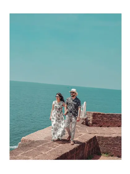 A classic pre-wedding portrait by the sea in Goa, capturing the couple's relaxed and happy vibe on their destination shoot.