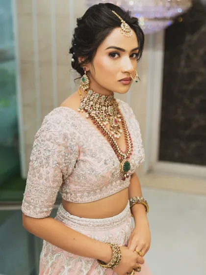 Twirl into a fairytale with this baby pink bridal lehenga. I designed it with intricate horse embroidery on the raw silk skirt and paired it with a heavily handworked blouse and a delicate net dupatta for a truly heavenly look.