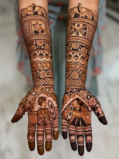 This bridal mehendi features portraits of a bride and groom in traditional wedding attire. The design also includes auspicious elements like Lord Ganesha and elephants.