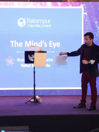 Explaining the premise of "The Mind's Eye" routine to an audience member. This act delves into prediction and intuition, creating a sense of mystery and wonder.