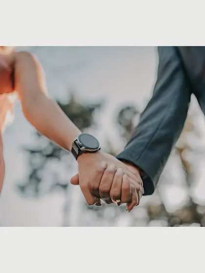 A close-up shot focusing on the couple holding hands. This simple yet powerful image symbolizes their connection and the start of their journey together, captured during their scenic pre-wedding shoot.
