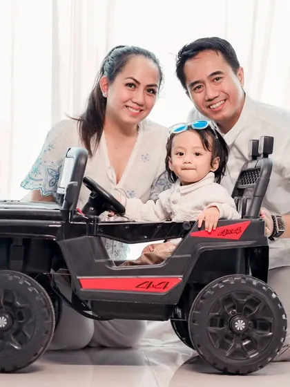 A picture-perfect family portrait. We used a fun toy car prop to engage the baby and bring genuine smiles to everyone's faces.