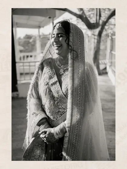 A beautiful, natural light portrait of the bride laughing, captured in classic black and white for a timeless feel.