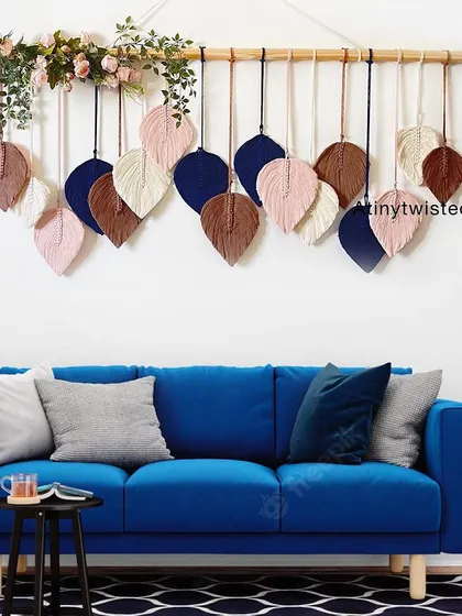 Here is one of my leaf wall hangings styled above a modern blue sofa. The contrast of the navy, brown, and pink leaves against the blue fabric is just stunning.