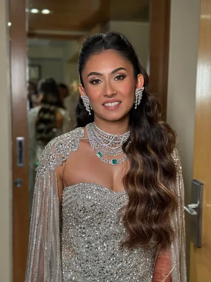 A full-sparkle look for an engagement celebration. The makeup was designed to complement her diamond jewelry and shimmering gown, featuring a flawless base, sculpted features, and a touch of drama in the eyes. It's all about creating that head-turning goddess mode.