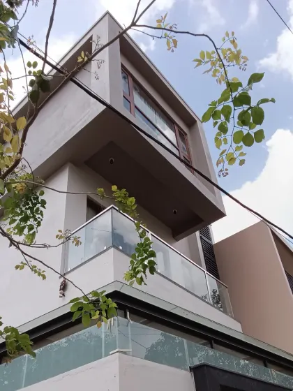 A look at a finished residential project where the design adds a sense of curiosity and life. The interplay of projecting and recessed volumes, along with clean lines and a glass balcony, gives this modern Bangalore villa its distinct character.