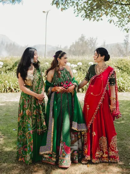 A beautiful portrait of the bride with her sisters. The natural light and stunning mountain scenery in Ooty created the perfect setting.