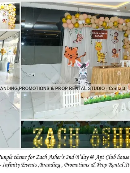 A simple and elegant jungle theme for a 2nd birthday at an apartment clubhouse. This setup uses a clean white backdrop with a gold and white balloon arch, cute animal cutouts, and marquee letters for a modern and stylish take on the safari theme.
