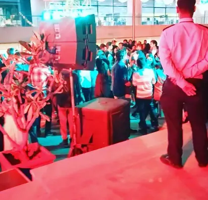 Even the security staff can't help but watch the energetic crowd at this outdoor mall event.