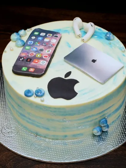 For the ultimate Apple fan, this cake is decorated with edible prints of an iPhone and a MacBook, along with fondant AirPods. It's the perfect way to celebrate a tech lover's birthday.