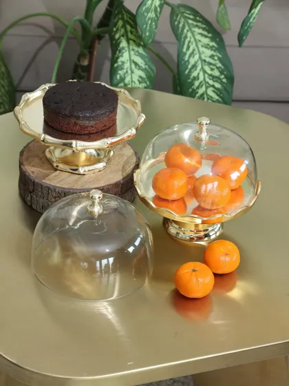 Our golden dessert stands with glass cloches, perfect for showcasing individual cakes or fruits. The polished gold finish and classic design add a touch of opulence to any dessert presentation.