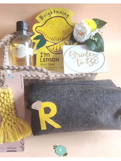 A "Bride to Be" hamper with a cheerful yellow theme. Curated by a bridesmaid, it includes a lemon face mask, a personalized pouch, and other pampering essentials for the final countdown.