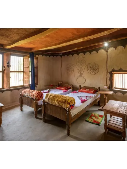 Another view of a homestay bedroom, built in collaboration with the local community. The entire process involved knowledge sharing, with elders guiding the construction and younger members providing the labor, resulting in a truly community-built space.