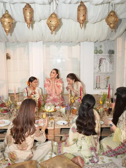 Guests enjoying the beautiful, low-seating arrangement at the Iftaar party, creating an intimate and communal dining experience.