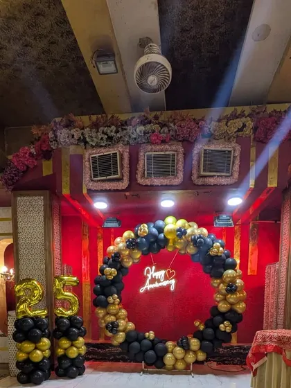 A wider view of the anniversary decoration, showing how it commands the stage in a large hall.