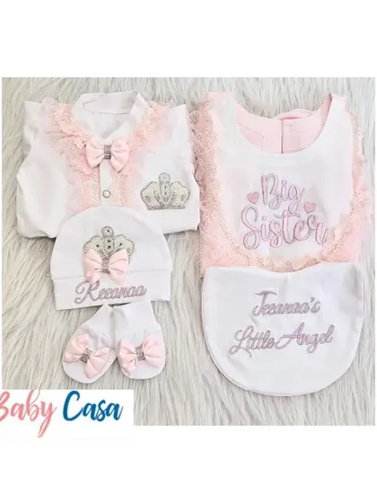 A sweet coordinated set for two sisters. The newborn gets a "Little Angel" romper and bib, while the older sister has a matching "Big Sister" bib to wear with her own outfit.