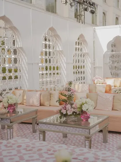 A seating area within the 'Mughal Garden' theme, featuring mirrored tables and custom-printed flooring that complements the intricate backdrops.