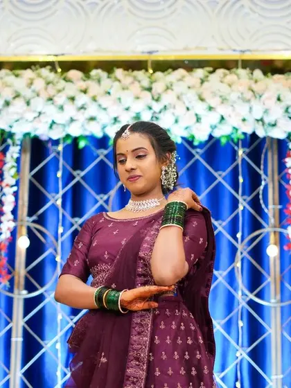 A beautiful portrait of a client with the decor in the background. The blue curtain with a crisscross light pattern and floral border creates a stunning photo opportunity.