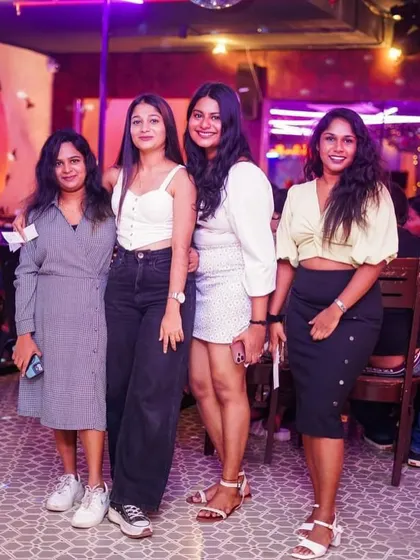 A group of friends dressed up and ready for a memorable night out.