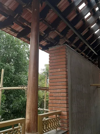 Another shot of the restoration in progress, showing the careful integration of new masonry with the existing wooden frame.