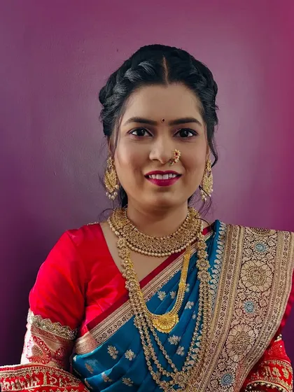 A happy bride is the most beautiful bride. This client is glowing in her Paithani saree, with a braided updo, traditional gold jewellery, and makeup that enhances her natural beauty.