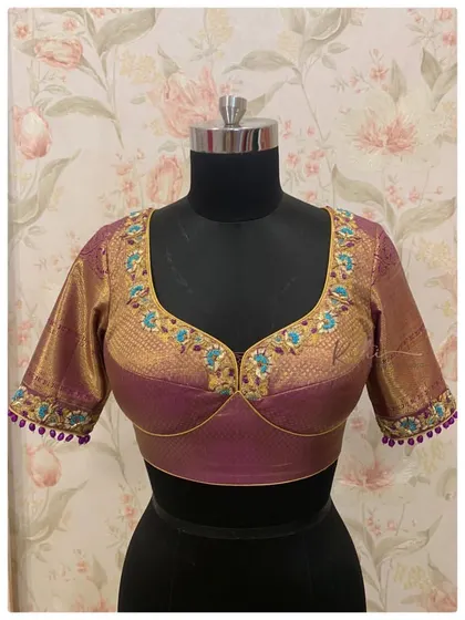 A violet silk blouse with a padded bustier design and intricate embroidery, perfect for a Kanjeevaram saree.