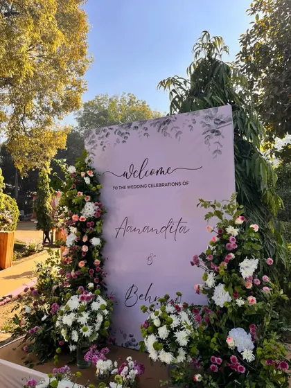 First impressions matter. This beautiful welcome board in a soft lavender hue, framed by lush pillars of white and purple flowers, set a tone of pastel elegance for the celebration.